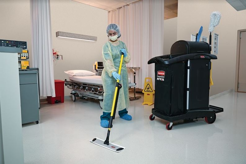 A hospital staff cleaning a ward using HYGEN™ PUlSE™ Microfibre Mop Kit and Rubbermaid Commercial Executive High Security Janitorial Cleaning Cart