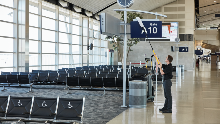 A cleaning staff of Shanghai Pudong International Airport on cleaning duty using RCP High Capacity Cleaning Carts, Mega BRUTE and HYGEN Microfiber Flat Mops