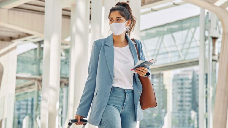 Woman with Luggage and Medical Mask 